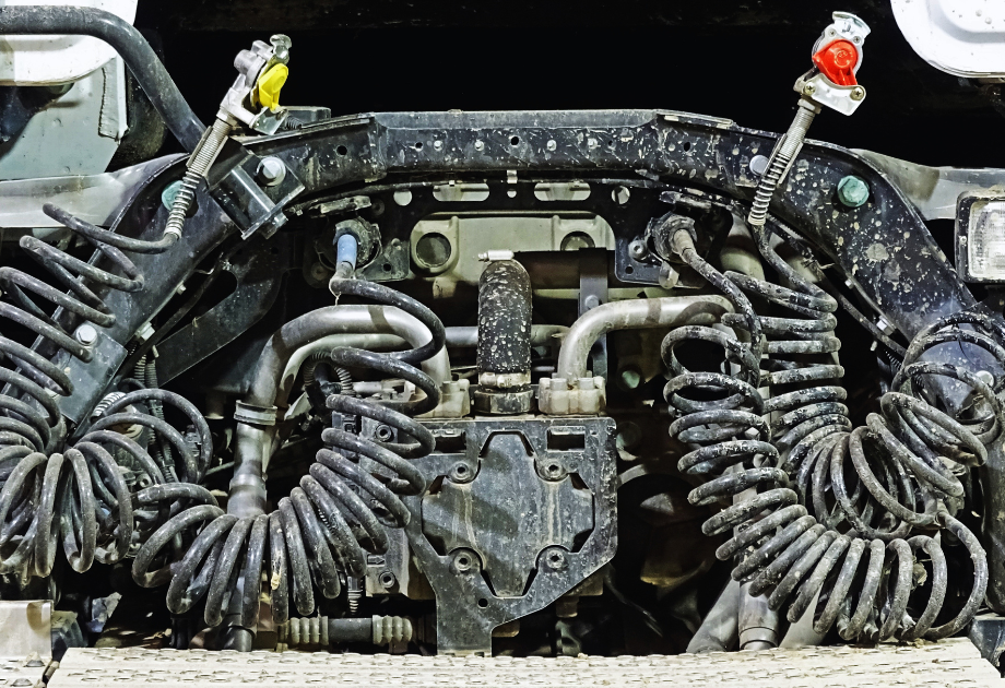 Close-up of truck tractor air brake and electrical lines connected at the rear of a semi-truck chassis.